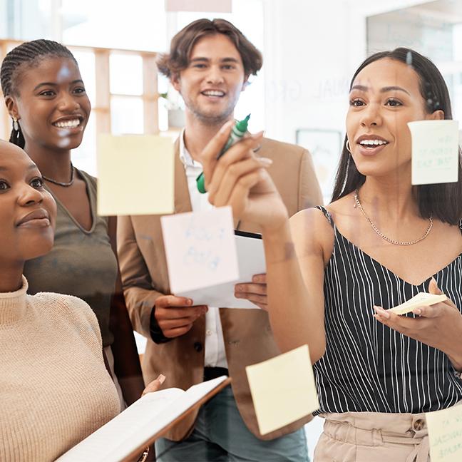 A group of employees working on a post-it note exercise.